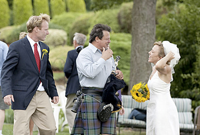 Tim Carey with his bagpipe talking to the bride